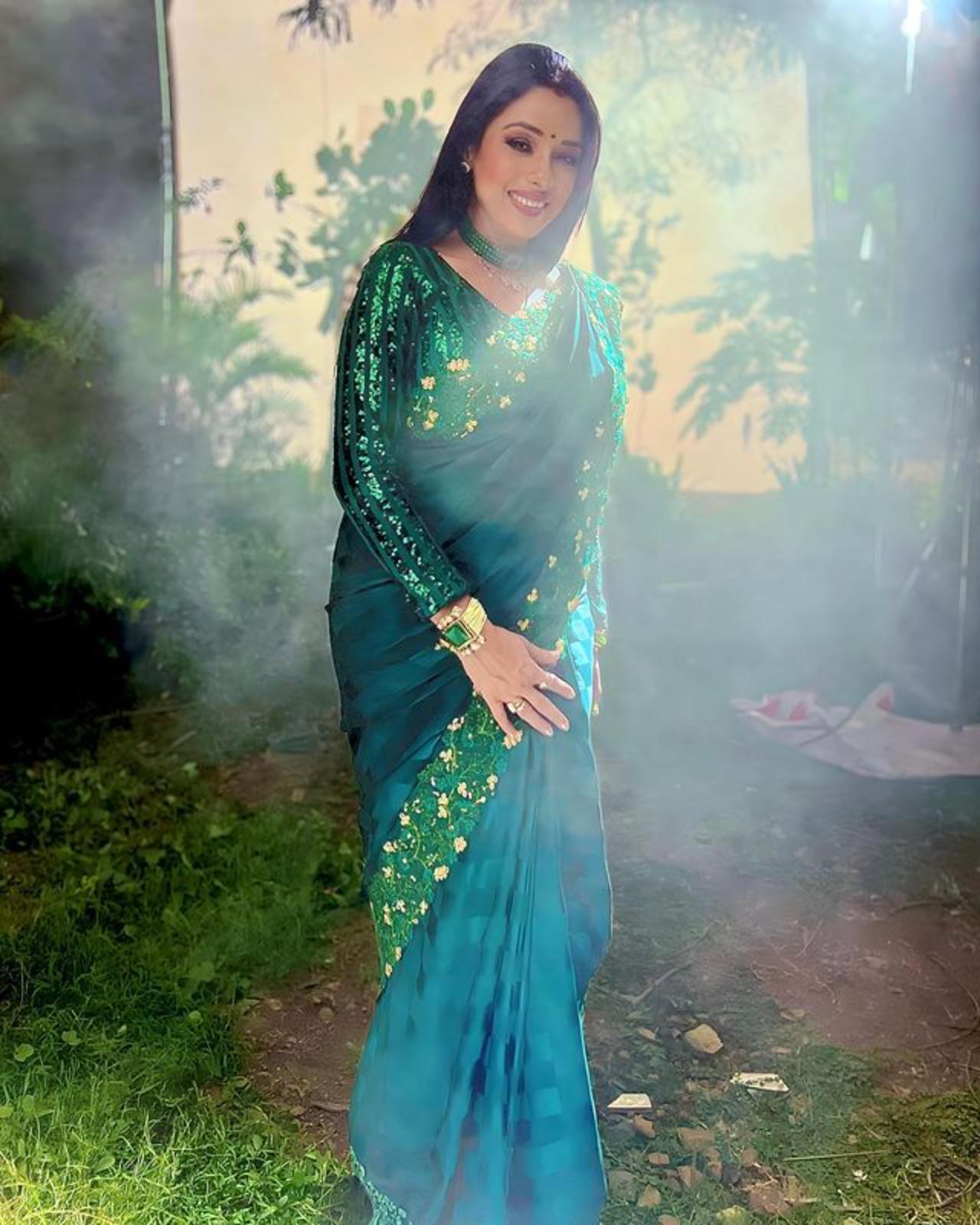 Rupali wore a plain green saree with a heavy border on a sequin blouse